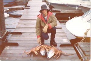 Proudly displaying catch of the day—a giant crab—while living in Alaska.