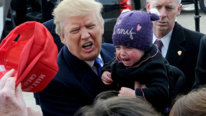 A baby cries in the hands of Republican presidential candidate Donald Trump when he speaks at a rally at Dubuque Regional Airport on January 30, 2016 in Dubuque, Iowa, USA. Photo by Dennis Van Tine/Sipa USA