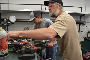 Kerry Moore and Michael Heckman machining on a metal lathe in the Advanced Manufacturing class at the Dell Reed Technical Center.